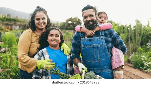 Indian Family Holding Basket Full Of  Organic Vegetables From House Garden Outdoor While Smiling On Camera   Vegetarian Healthy Food And Education Concept   Focus On Father Face