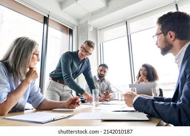 Male Mature Caucasian Ceo Businessman Leader With Diverse Coworkers Team Executive Managers Group At Meeting Multicultural Professional Businesspeople Working Together On Research Plan In Boardroom