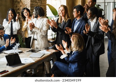 Multigenerational Colleagues Clapping Hands For A Succesful Green Energy Project Inside Business Modern Office   Teamwork Greeting Each Others For Environmental Deal   Main Focus On Asian Man Face