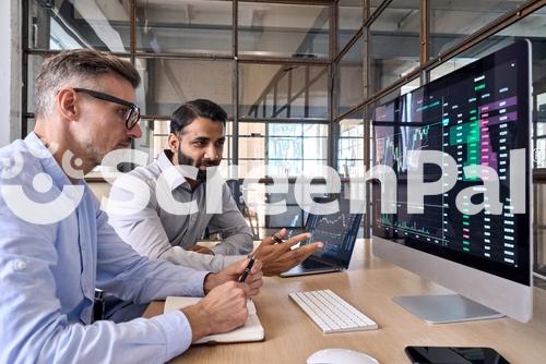 Two Diverse Crypto Traders Brokers Stock Exchange Market Investors Discussing Trading Charts Research Reports Growth Using Pc Computer Looking At Screen Analyzing Invest Strategy Financial Risks