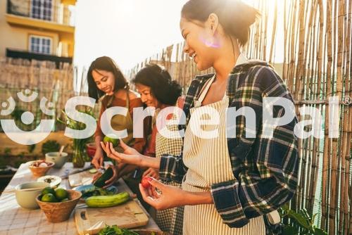 Asian Family Cooking Together At Home Patio Outdoor   Mother And Two Daughters Having Fun Preparing Dinner At House Backyard   Main Focus On Right Girl Face