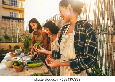 Asian Family Cooking Together At Home Patio Outdoor   Mother And Two Daughters Having Fun Preparing Dinner At House Backyard   Main Focus On Right Girl Face