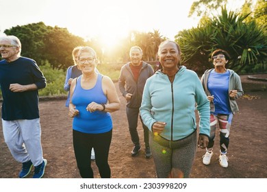 Fit Senior People Running At City Park   Group Of Elderly Friends Doing Sport Workout Together Outdoor   Main Focus On African Woman Face