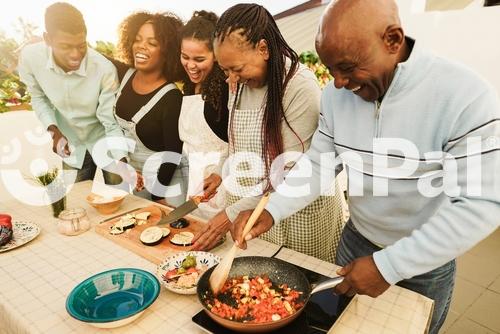 Happy African Family Cooking Outdoor At Home Rooftop Terrace During Summer Time   Sunday Dinner Community Concept   Focus On Mother Face