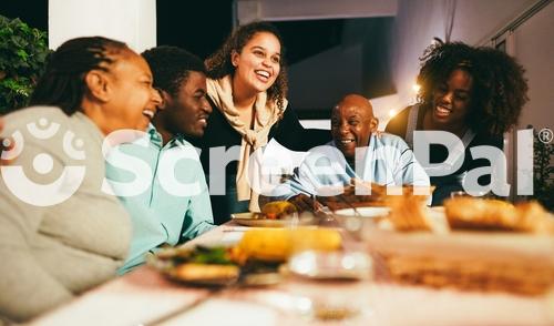 Happy African People Eating Dinner Together At Home Terrace Outdoor   Holidays And Family Concept   Soft Focus On Senior Woman Face