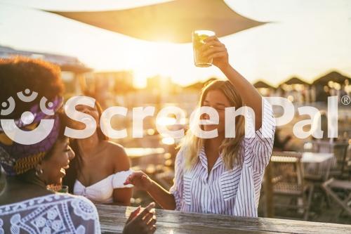 Happy Girls Having Fun Drinking Cocktails At Bar On The Beach   Soft Focus On African Girl Face