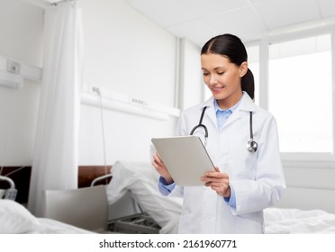 Healthcare Technology And Medicine Concept   Smiling Female Doctor With Tablet Pc Computer Over Hospital Ward Background