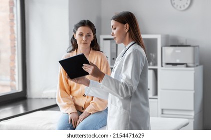 Medicine Healthcare And People Concept   Female Doctor With Tablet Pc Computer Talking To Woman Patient At Hospital