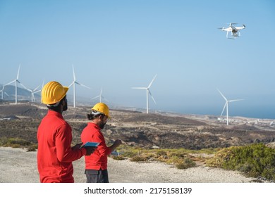 Multiracial Engineer Men Working On Windmill Farm With Digital Tablet And Drone   Renewable Energy Concept