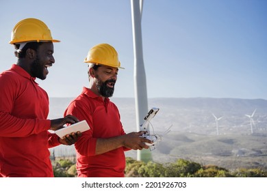 Multiracial Engineer Men Working On Windmill Farm With Digital Tablet And Drone   Renewable Energy Concept