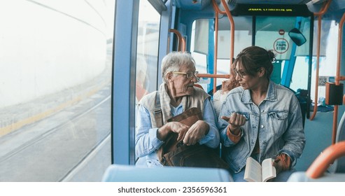 Senior Man And Mature Woman Talking Together While Traveling With Tram Transportation   Soft Focus On Man Face