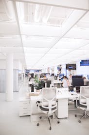 White Plastic Chairs And Tables In White Room